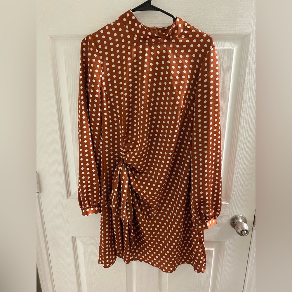 Long sleeve high neck burnt orange and polka dot dress.